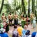 A group of Māori performers onstage in front of an audience in a forest